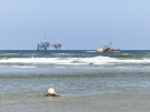 ameland-june-2021a-fishing-boat-between-a-tree-stub-and-a-gas-rig