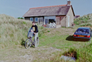 Our first visit to Wadden island Ameland (june 1993) - Arie leaving the holiday cottage on a bike with Elvin in front of him