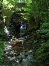 vallee de misere - a waterfall under a bridge