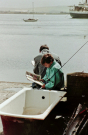 the sea front of stromness with people fishing